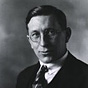 Black-and-white photo of F. G. Banting wearing round glasses, a tie, vest, and jacket.