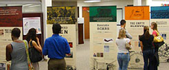 People gathered around a series of banners.